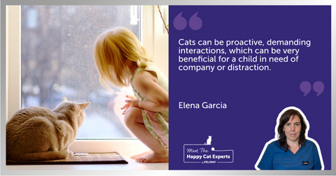 Young girl and cat looking through a window.